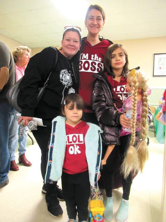 SPECIAL SHOPPING: Kelly Andrade and Ashlee Loverdi and children Ariana Loverdi and Olivia Loverdi show off items like a doll with pigtails they purchased in the White Elephant Room Saturday.