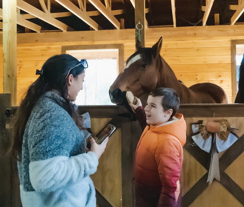 A BIT OF BRUSHING: Karrina Botelho and Jacen LaFontaine brush Jackie inside the barn at Equi Evolution. The field trip, for third through fifth grade students at Stone Hill Elementary School with autism spectrum disorder, provided students the ability to learn about the farm&rsquo;s horses, what they eat and how the farm takes care of them.