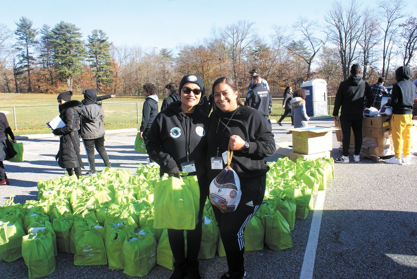 HELPING SO MANY: Executive Director of Esperanza-Hope Wilda Gutierrez (left) and volunteer/board member Ruth Garcia were busy Saturday handing out food to the public. Gutierrez was thrilled that the two nonprofits were able to help so many families during the holiday season.