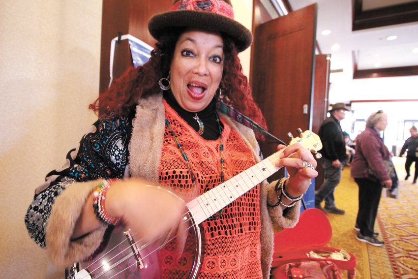 SHARING A TUNE: Doli Grace of Warren brought along her ukulele and her colorful outfit to brighten the day for those attending Small Business Saturday. She said more than the dollars dropped in her instrument case she valued the kids who danced to her music and in particular the boy who pulled the lollipop from his mouth to give it to her. &ldquo;Just think what that meant to him,&rdquo; she said.