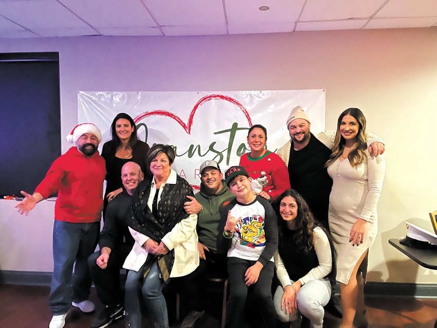 TEAM WORK MAKES THE DREAM WORK: The board members of Cranston Cares take a moment out of the revelry to pose for a picture at the toy drive inside the Park Theatre on Nov. 29.