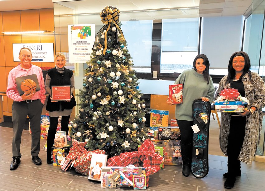 SPIRIT OF GIVING: At its Park Avenue branch, pictured, BankRI&rsquo;s Holiday Giving Tree program collected 70 gifts for children served by Aids Care Ocean State. The bank&rsquo;s Atwood Avenue location received 147 presents to benefit kids at SSTARbirth, while the Plainfield Pike branch collected 65 gifts in support of Comprehensive Community Action Program. Statewide, the effort led to 5,556 gifts for underprivileged children. From left: Mike Reynolds, Business Development Manager, Aids Care Ocean State; Jenn Parrillo, AVP, Park Avenue Branch Manager; Linda Lussier, Senior Teller; and Nicole Pomeranze, Senior Teller.