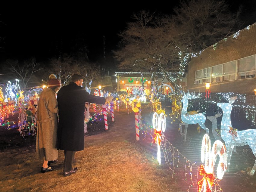 ADMIRING THE DISPLAY: Visitors stop to admire the lights display at Praise Tabernacle. (Herald photo)