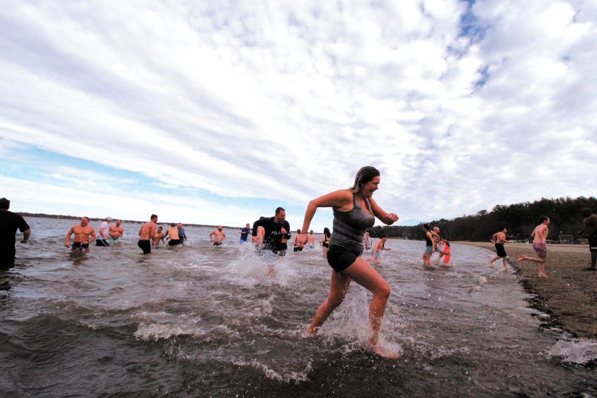 IN AND OUT QUICKLY:  some find the courage to take the plunge in knee-deep water, others race to find towels at the New Year&rsquo;s Day Obstaplunge and Frozen Clam Dip to benefit Mentor RI at Goddard Park. More photos and a story on page 9. (Cranston Herald photos)