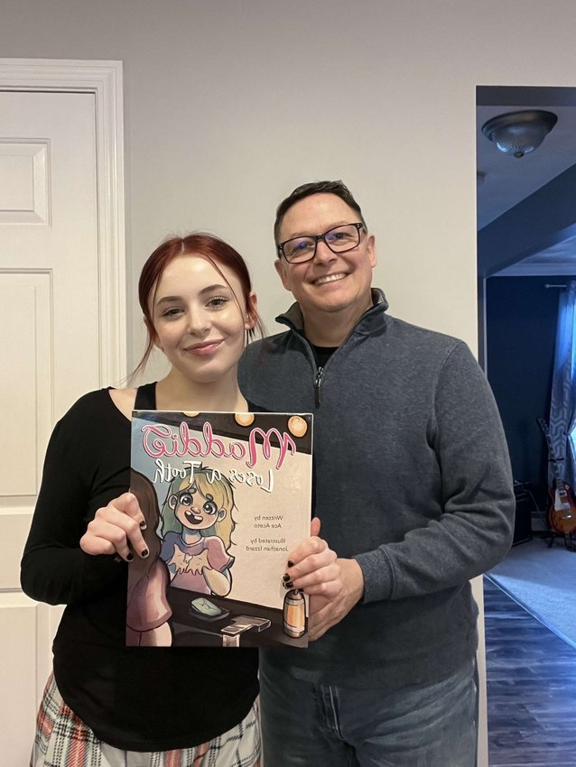 THE AUTHOR AND HIS MUSE: Ace and Maddie Aceto pose proudly with the book that will make them famous. (Photos courtesy of Ace Aceto)