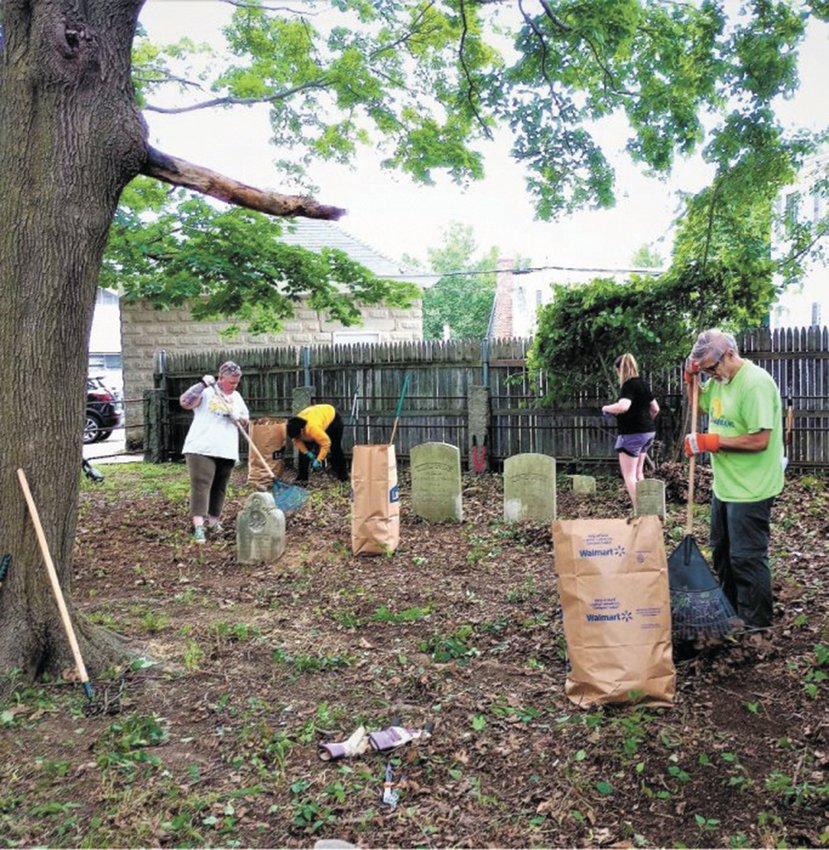 OVERGROWN AND HIDDEN STONES: The Cranston Historical Cemeteries Commission (CHCC) cleaned up the John Stone Lot on Frankfort Street near Twin Oaks in June of 2022. The site was overgrown with plants, which commission members cleaned up. According to the Cranston Historical Cemeteries Commission (CHCC), the most notable burial in the lot is of Seneca Stone who was a member of the town council and represented the city in the House of Representatives in the early 1800s. He was also the town treasure and member of the first Cranston School Committee. Pictured (from left) are Jennifer Wendt, Nicole Johnson-Morais, Makenna Hanson and John Hill. (File photo)