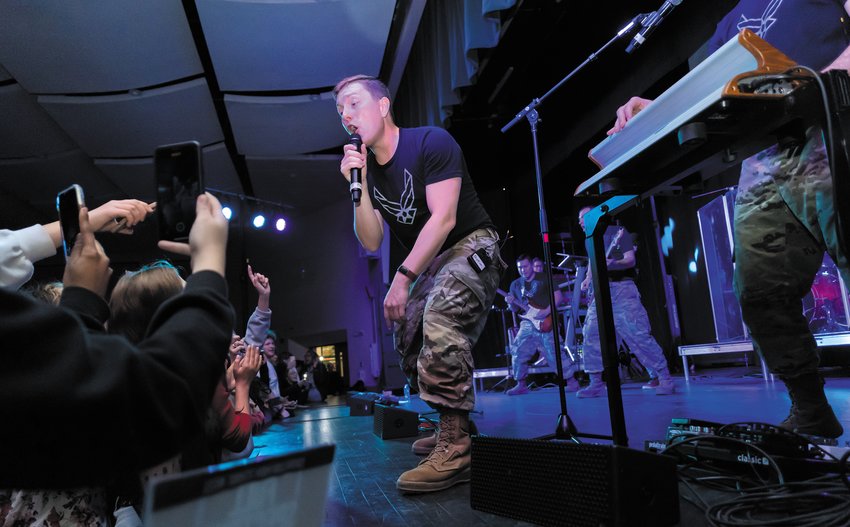 ENERGIZING THE CROWD: Air Force Airman 1st Class Benton Felty pumps up the crowd during the Full Spectrum Band&rsquo;s performance at Cranston High School East on Feb. 14.