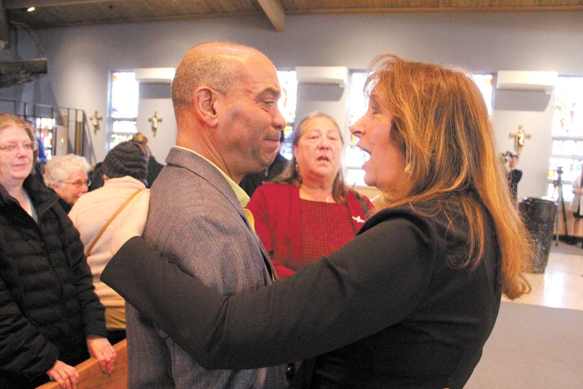 IN A SHOW OF SUPPORT: Sue Stenhouse, who worked the family resource center following the fire, greets Jody King who lost his brother, Tracy, to the fire. Looking on is fire survivor Robin Petrarca. (Cranston Herald photo).