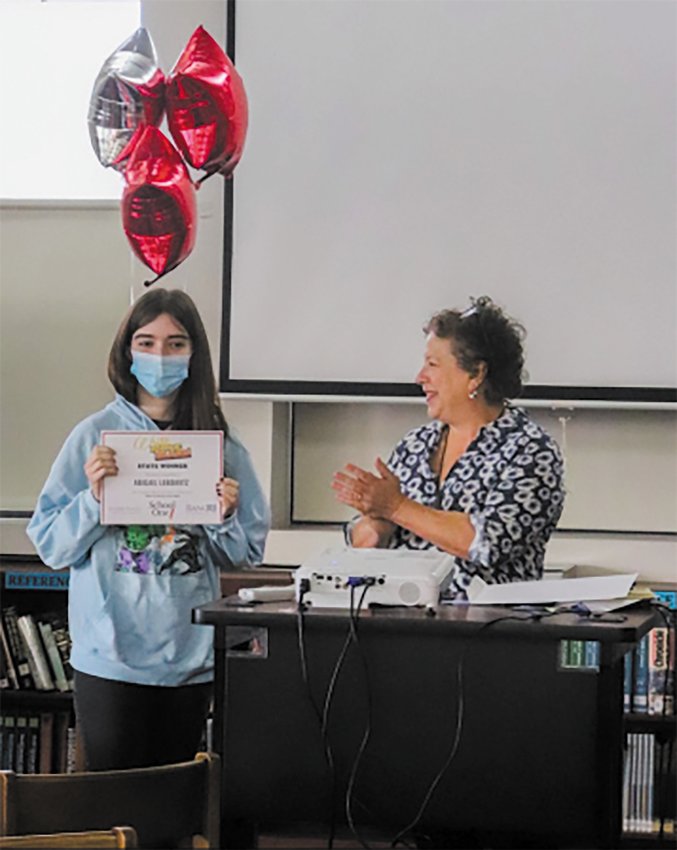 RECOGNITION INCOMING: Senior Abigail Lebowitz poses with her award from Write RI with its co-founder Hester Kaplan (Photo by Devyn O&rsquo;Donnell)