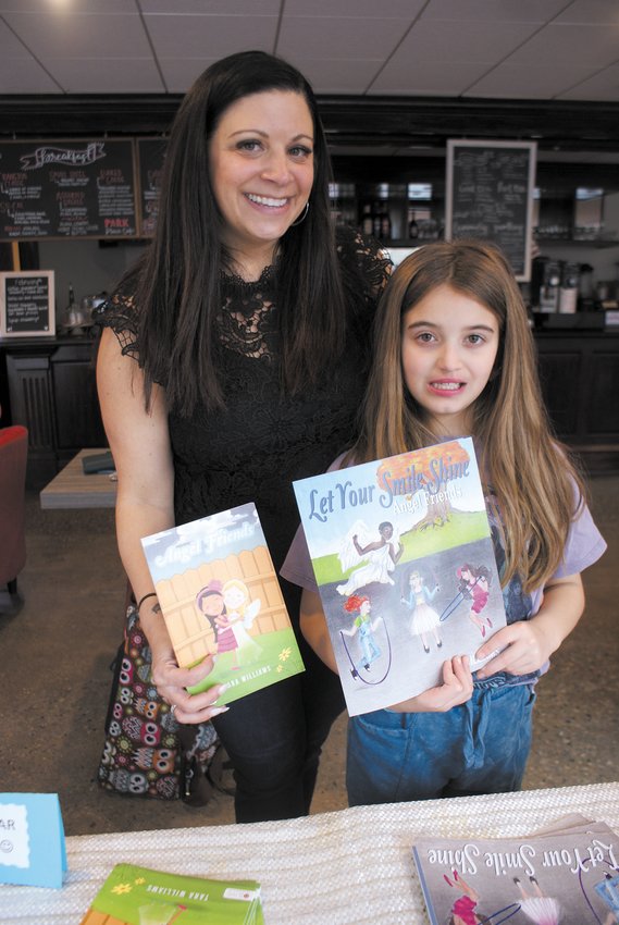 PARENT AND AUTHOR: Tara Williams stands with daughter Aria displaying the two books Tara wrote; &ldquo;Angel Friends&rdquo; and &ldquo;Let Your Smile Shine.&rdquo; (Photo courtesy of Steve Popiel)