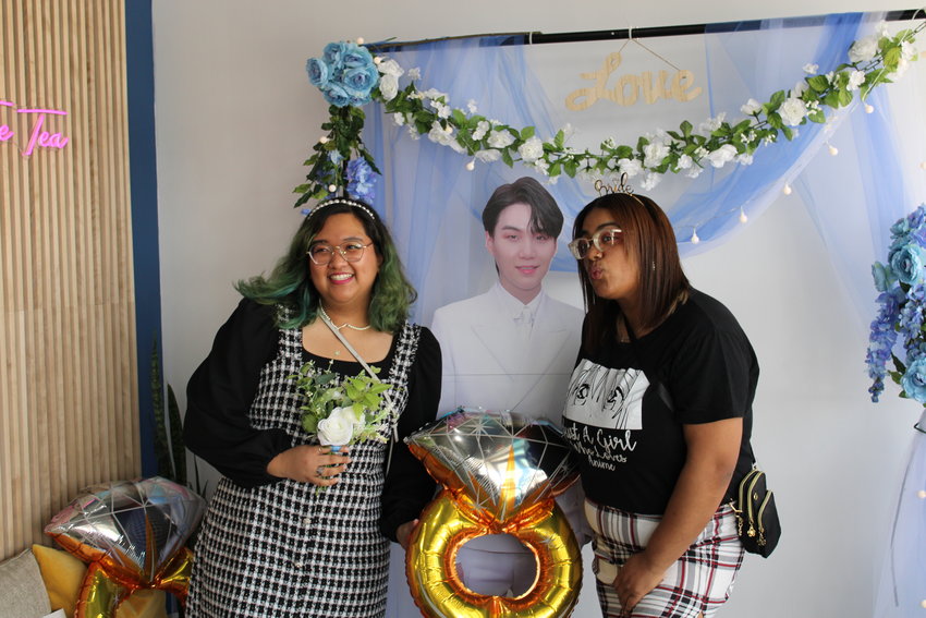 I DO: Abi prodigalidad and Elizabeth Ortiz happily take a photo with a cardboard cutout of BTS band member, Suga.