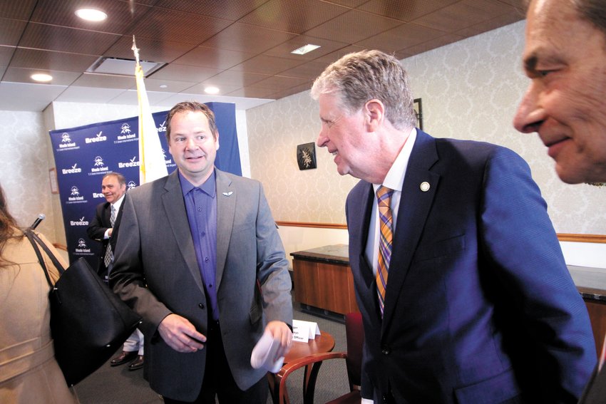 AT ANNOUNCEMENT: Breeze Airways Chief Operations Officer Mike Wuerger chats with Gov. Dan McKee before heading to the Breeze counter to snip a ceremonial ribbon.