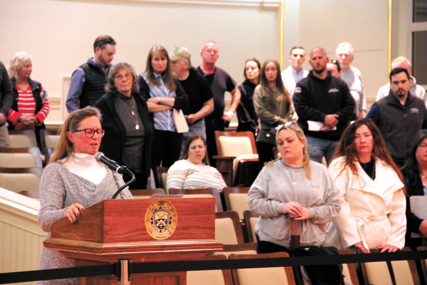 STANDING UP AGAINST A CHANGE IN TAXATION: Showing their support, members of the business community stood as Central RI Chamber President and CEO Lauren Slocum urged the council to deny a provision allowing the city to alter the ratio between the residential and commercial tax rates. (Warwick Beacon photo)