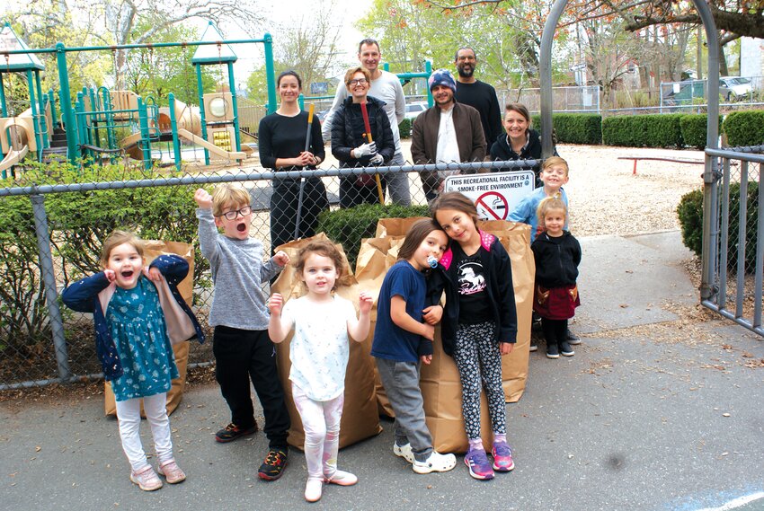 Keeping it clean all over the city: Students, parents and teachers work together at Rhodes Elementary to clean and revitalize their school grounds (more photos on page 8). With the arrival of Earth Day, cleanup initiatives are happening all over the city. (Photos by Steve Popiel)