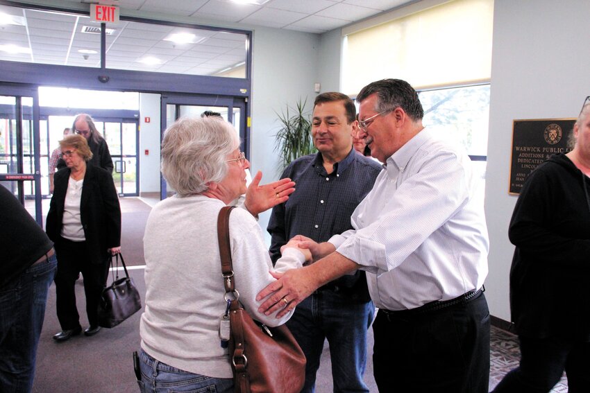 GREETING: House Speaker K. Joseph Shekarchi and Senator Mark McKenney chat with constituent Pearl Holloway prior to a listen session the two legislators held Saturday at the library. Rep. Joseph Solomon joined them. (Warwick Beacon photos)