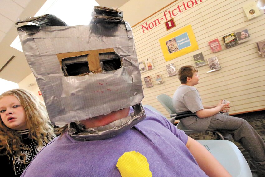 AND WHO MIGHT THAT BE? Kids created their own costumes to join in the fun at the library. (Warwick Beacon photos)