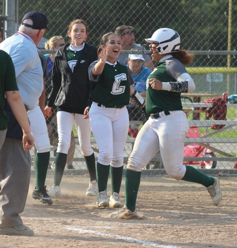 PLAYOFF READY: The East softball team gathers around the plate to celebrate a home run. (Photos by Alex Sponseller)