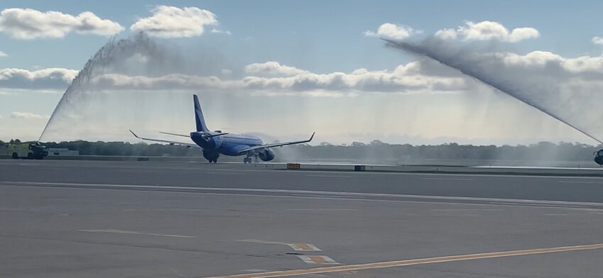 SEEING THEM OFF: Breeze Airways&rsquo; first nonstop flight from T.F. Green to Los Angeles takes off Wednesday morning while being seen off by the airport&rsquo;s fire trucks and twin arches of water. (Courtesy of RI Airport Corporation)