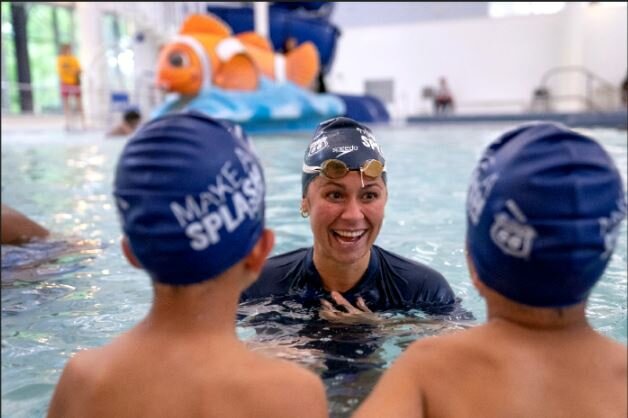 IN THE WATER WITH STUDENTS: Elizabeth Beisel teaches students to &ldquo;make a splash&rdquo; when it comes to swimming.