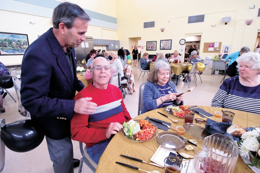 SAYING THANKS: Mayor Picozzi made the rounds at Pilgrim Senior Center Monday thanking volunteers for all the work they do. Here he talks with Larry King and his wife, Hope. (Warwick Beacon Photo)