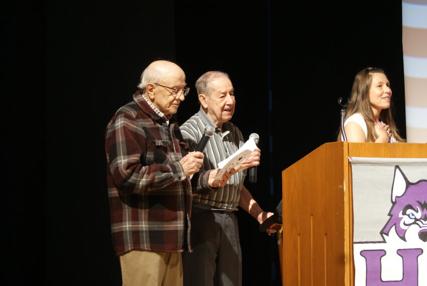 100 YEARS OF HONOR: Luis Giarrusso (left) stands beside possible cousin Domenic Giarrusso as they read the Pledge of Allegiance before the assembled students next to the events MC, Seventh Grade Teacher Michaela Horta. Mr. Domenic Giarrusso, and Mr. Louis Giarrusso, who are both 100 year old World War II veterans, joined together to read the Pledge of Allegiance to the entire student body. Having recently met for the first time, Luis and Domenic found out that they may actually be cousins. Domenic was a member of the Army Air Corps stationed in the Atlantic during WWII and Luis served in the infantry in Southeast Asia. The entire Student Body attended the ceremony, a total of about 350 students. (Photos by Steve Popiel)