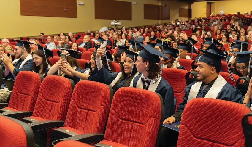 BUILDING ADULTHOOD: Graduating from Cranston&rsquo;s Construction and Career Academy, students take selfies in their caps and gowns before the ceremony begins. (Photo by Stephanie Bernaba)