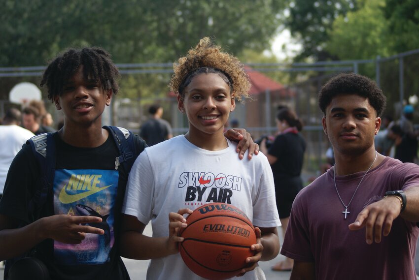 THE CREW: Mya Jimenez, a soon to be senior at Cranston High School East, prepares for their game with her team, The Nets. Beside her are teammates Jhamil Cuello (left) and Andrew Gray (right).