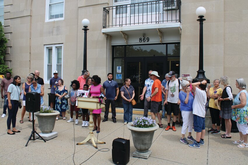 STANDING TOGETHER: A crowd of people supporting the effort to maintain the current size and capacity of Budlong pool while bringing it up to ADA compliance gather in front of City Hall with City Council members Aniece Germain, of Ward 2, John Donegan, of Ward 3, and City-wide Council member Robert Ferri to present the Mayor&rsquo;s office with a petition signed by almost 2,000 Cranston residents. (Herald Photo by Ed Kdonian)