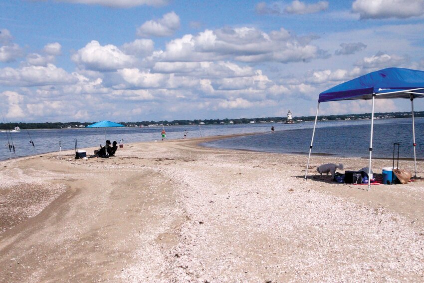 ALLURING POINT: The Conimicut Point sandbar offers panoramic views of Narragansett Bay and the Providence River, but it can be treacherous during tidal changes. This view showing beach goers and fishermen was taken Saturday. (Warwick Beacon photos)