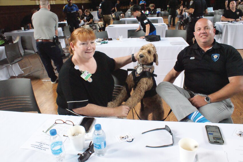 STANDING PROUD: Dr. Christine Barron and Detective Michael Iacone smile and show off the star of the show, therapy dog Cali. (Photos by Steve Popiel)