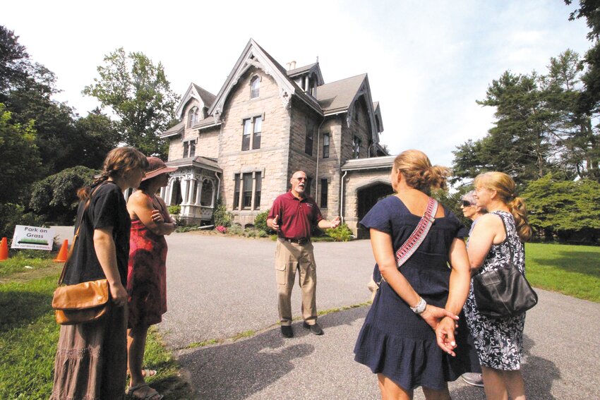 TURNING BACK THE CLOCK: Clouds Hill Vice President and Director of Operations, Wayne Cabral tells the story of what was once a 500 acre estate including a dairy farm before conducting a recent tour of the Victorian mansion in Cowesett. (Warwick Beacon photos by Will Steinfeld)