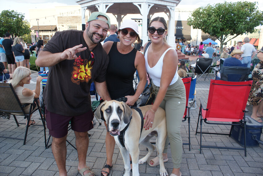 ENJOYING THE SHOW: Co-owner of the Thirsty Beaver Ed Brady and his wife Taylor (right) attend the concert with their friend Jess Simone and her best friend Moose, a seven-month-old great dane.