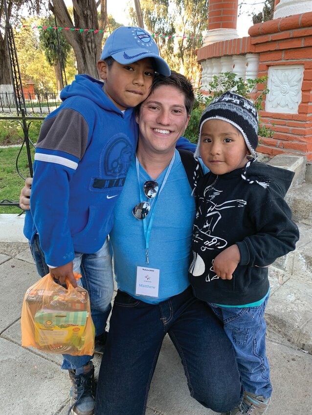 MAKING A DIFFERENCE: Matthew Gebhart (center) smiles as he visits Bolivia to see the boy he sponsors, Jhamil (left), and his brother, sponsored by Gebhart&rsquo;s parents, Jhafet in 2019. (Submitted Photo)