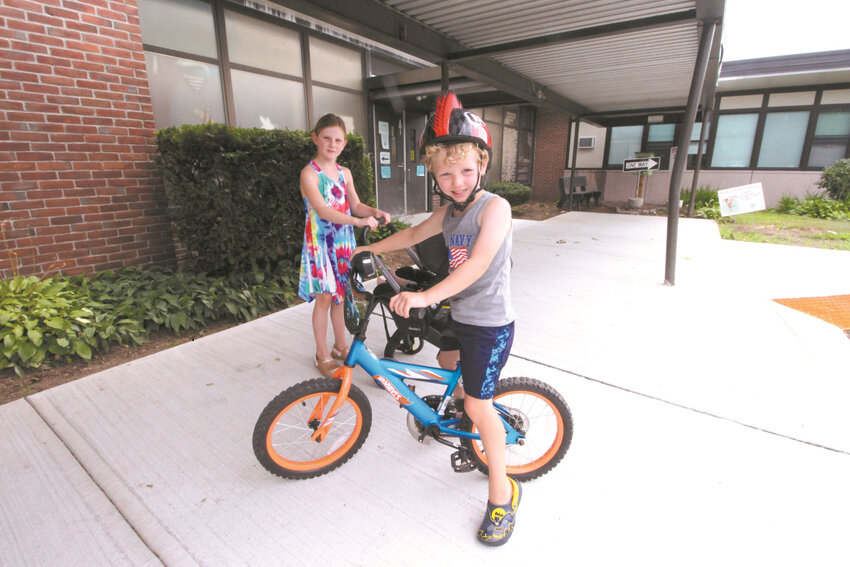 NOTHING BETTER: Holliman School neighborhood kids, Lizzy Sedlor and her brother Jake, try out their