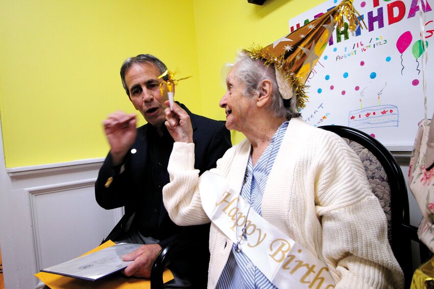 A TEASE AT 100:leanor Butterfield Dansereau who celebrated her 100th birthday Thursday at the Warwick Health Center, tweaks Mayor Frank Picozzi, with a noisemaker at a party attended by scores of her relatives. He presented her with a proclamation. Story and more photos on page 7. (Warwick Beacon photos)