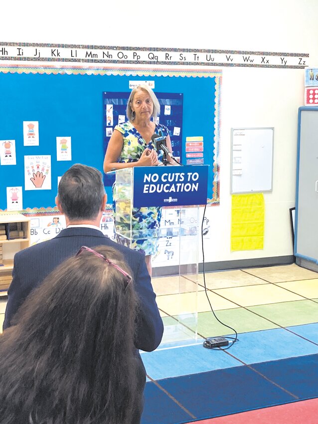 DENOUNCING A DOWNSCALE: Congressman Seth Magaziner watches as Michelle Wolstenholme, CEO of CHILD, Inc., talks about the importance of funding for the nonprofit organization. (Warwick Beacon photo)