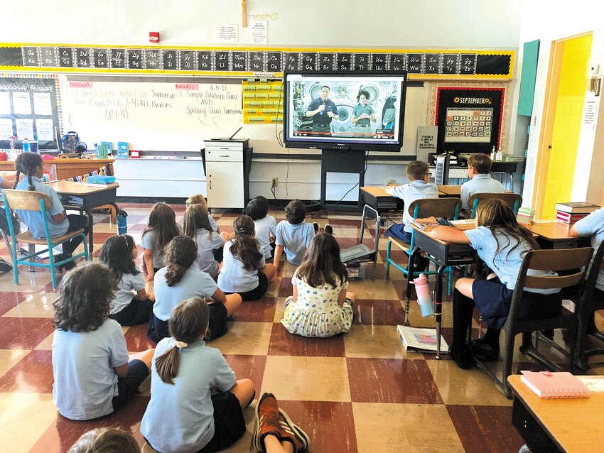 SPACE-TIALLY AWARE: Students at St. Peter School watch as Frank Rubio (left) and Jasmin Moghbeli answer their questions about outer space. (Warwick Beacon photo)