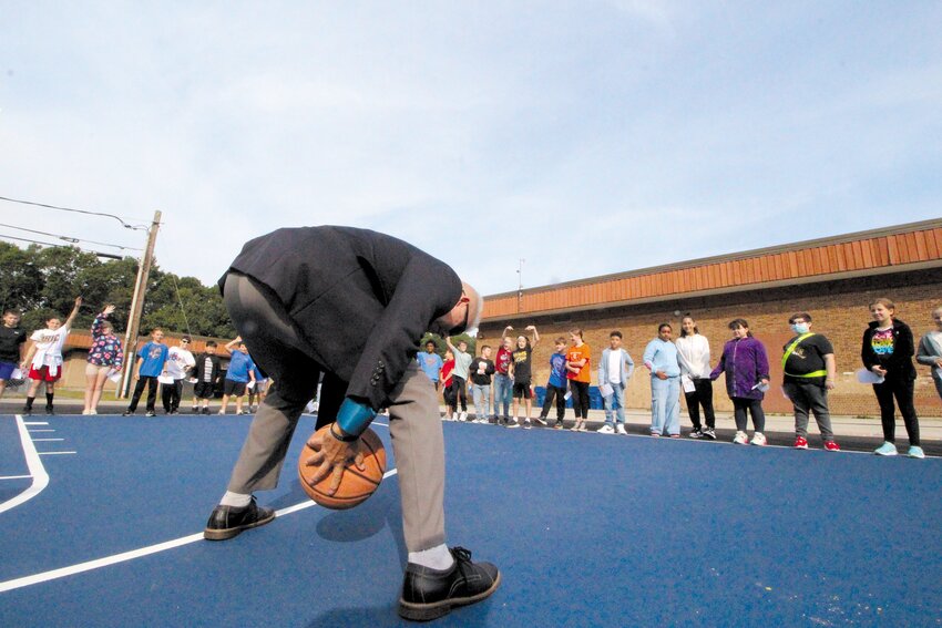 SHOWING SOME SKILLS: Hoxsie Principal Gary McCoombs shows off a between-the legs dribble as the ceremony begins. (Warwick Beacon photos)