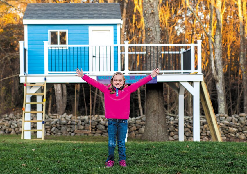 WHAT SHE WISHED FOR:  Gracie, whose wish for a treehouse was granted in collaboration with Bentley Builders of Warwick demonstrates her appreciation. Bentley Builders  was a tournament sponsor. (Photo by Jennifer Lima Photography)