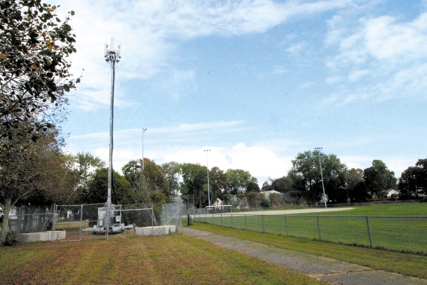 TEMPORARY COW: This COW (Cell On Wheels) has served to replace the Conimicut cell phone tower next to Clegg Field that caught fire last summer. The City Council will consider a change of zone in a wooded area south of the field allowing for the erection of a new tower, which it is hoped will also bring improved service. (Warwick Beacon photo)