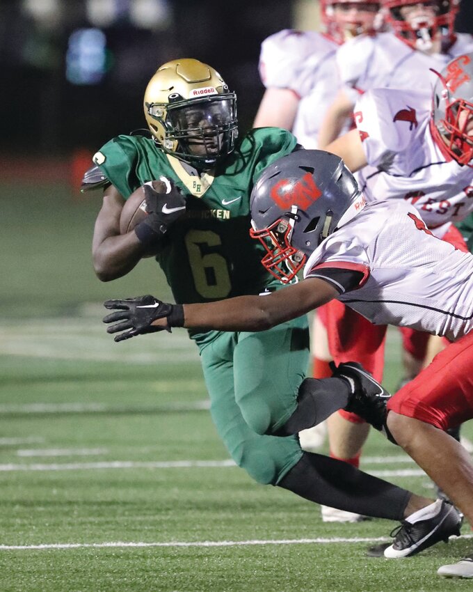 BATTLE OF THE BIRDS: Hendricken running back Josiah Dennis picks up yards. (Photos by Mike Zawistoski)