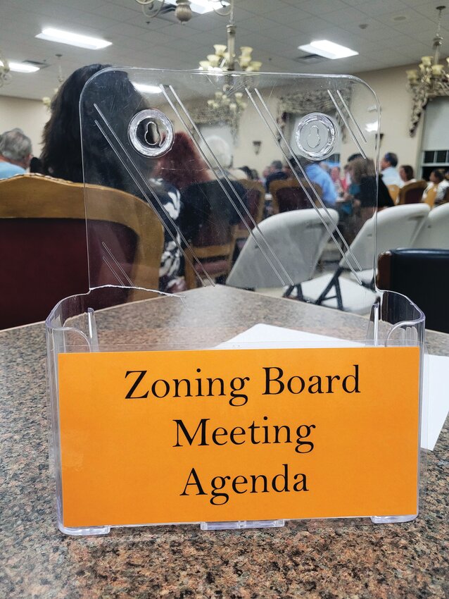 CRAVING SUNSHINE: The agenda rack was picked clean at last Thursday&rsquo;s Zoning Board meeting. For a while, it was standing room-only at the Senior Center. (Cranston Herald photo by Rory Schuler)