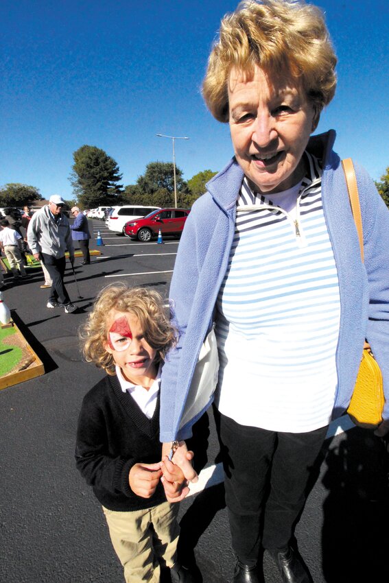 PAINTED FOR THE OCCASION: Peter Robbins stayed close to his grandmother Madeline Perreault as they joined students and grandparents for outdoor activities during grandparents&rsquo; day. Face painting was one of the activities Robbins participated in.