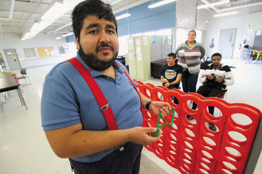 GAME TIME: Adult students at the Pathways program operating from Commonwealth Avenue in Warwick play a game during a break in classes. Some of these students have part time jobs, attending classes twice a week. Here Peter Megrdichian takes on Jordan Cook and Donald Roach. Younger students and administrative offices are based at the Pathways Center in Coventry. (Warwick Beacon photos)