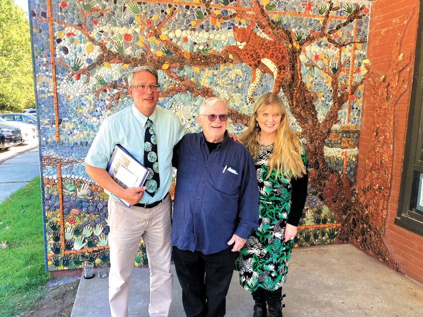 A JOB WELL DONE: Former principal Martin Susla (left) poses with artist Peter Geisser and art teacher Kim Gallman in front of the completed mural. (Beacon Photo by Adam Zangari)