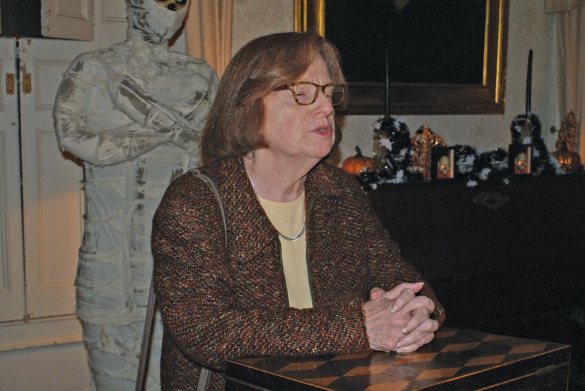 PREPARING TO SCARE: President of the Cranston Historical Society Sandra Moyer welcomes the crowd and introduces the night&rsquo;s speaker.