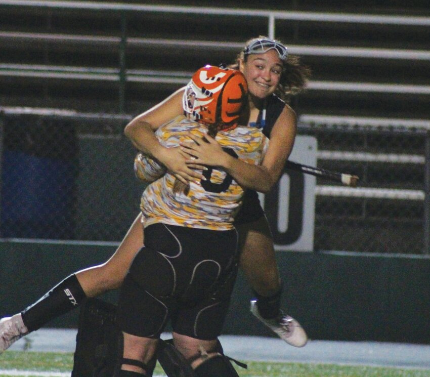 Pilgrim&rsquo;s Asia Jean-Baptiste celebrates with goalie Valerie Landry. (Photos by Alex Sponseller)