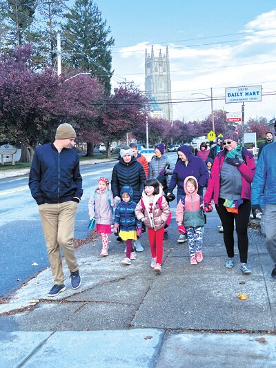 A DAILY WALK: Students from Rhodes elementary march down Broad Street as part of a national walk to school in honor of one of America&rsquo;s most famous elementary school students, Ruby Bridges. To remember the bravery of Bridges and other black students who chose to attend recently integrated schools during the civil rights movement despite discrimination and threats of violence, students, parents, and teachers from Eden Hill and Edward S. Rhodes elementary schools walked to school in the cold, just like Bridges once did.