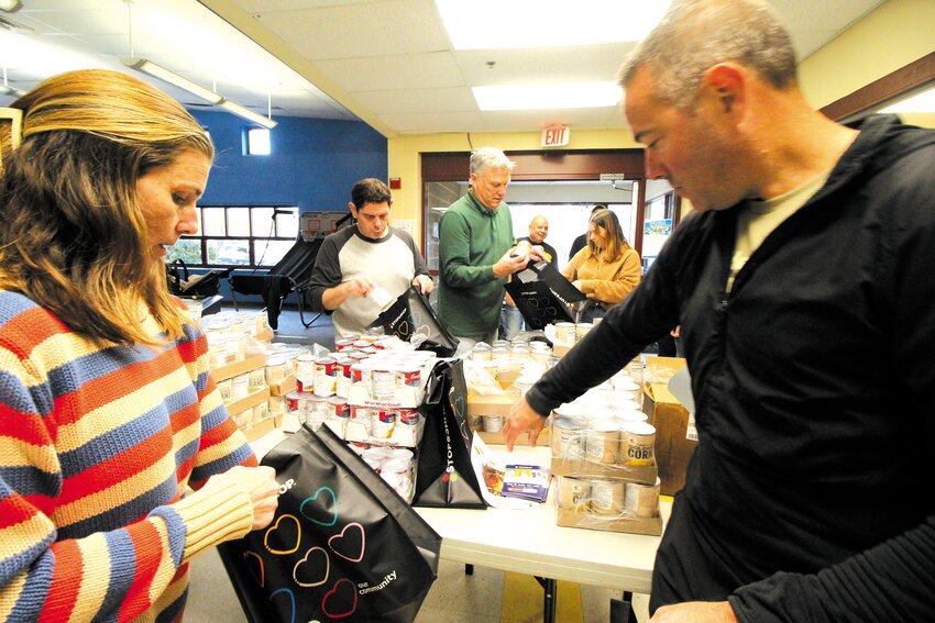 TURKEYS BY THE BOXLOAD:  In preparation of Saturday&rsquo;s distribution of more than 200 turkeys and bags with all the fixings, courtesy of  Stop &amp; Shop, Boys and Girls Clubs executive director Lara D&rsquo;Antuono  and board members  Tom Sweeney and Bradford Connor unpack the frozen birds.