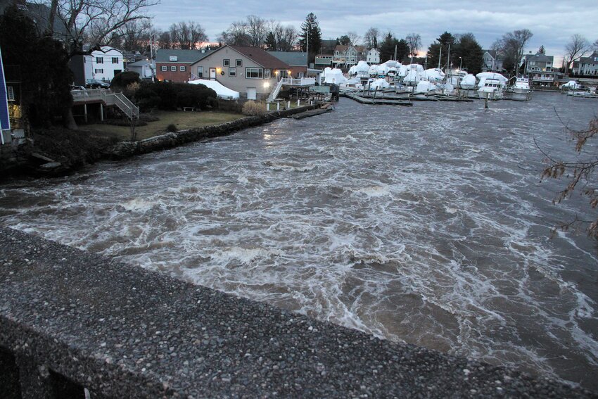 ROARING PAWTUXET: Not that we need a reminder that there&rsquo;s plenty of water to go around but  rather, too much of it, the Pawtuxet River has been at flood levels for days now. This image was taken from the village bridge late Wednesday afternoon prior to yet another storm on Saturday. (Cranston Herald photo)